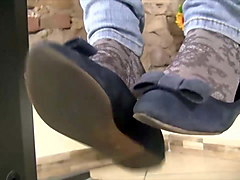 Teen feet in socks with white nail polish