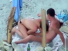 Topless girlfriend sucking his big cock at the beach